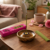 Encens japonais Morning Star Rose allumé avec porte-encens, tasse et rose dans un intérieur zen